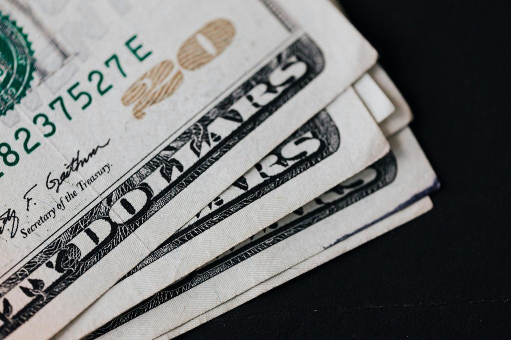 Dollar bills fanned out on table